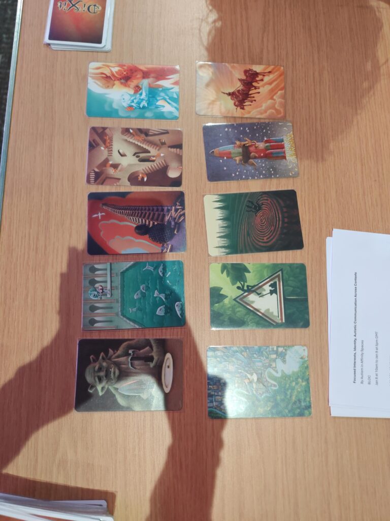 Cards from the Dixit game. Starting from top then left to right, they feature: - A water elemental and fire elemental embracing - A rider with several masked horses, riding through the clouds - Foxes navigating an Escher-esque staircase labyrinth - A cat and dog tied to a rocket - A child sitting at the bottom of a tower made from building blocks - A scarab beetle emerging from a labyrinth - A fish about to dive into a swimming pool filled with other fish - A stickman emerging from a danger sign - A goblin with a hammer, spade, and a plate with a pea - Someone walking a tightrobe above a city